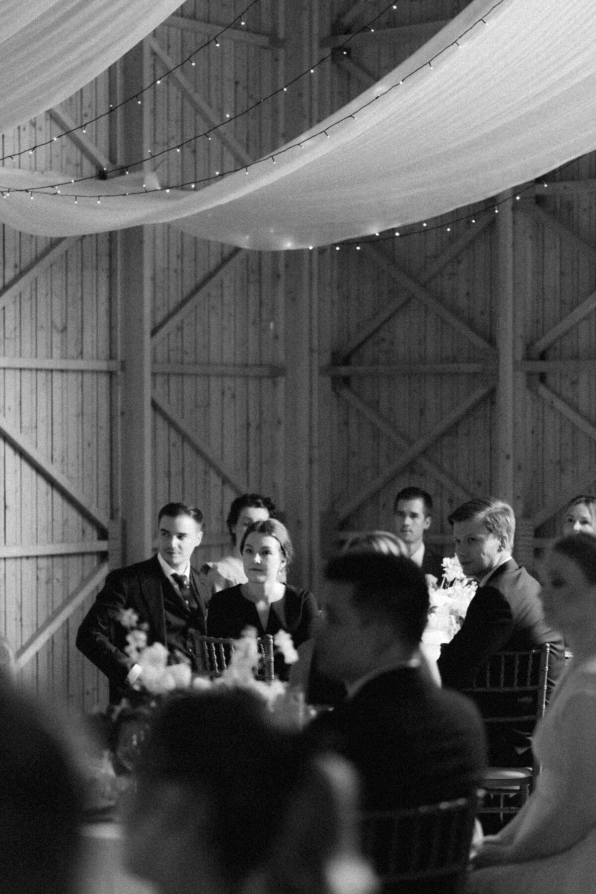 Guests listening to the speech in the wedding. Image captured by wedding photographer Hannika Gabrielsson.