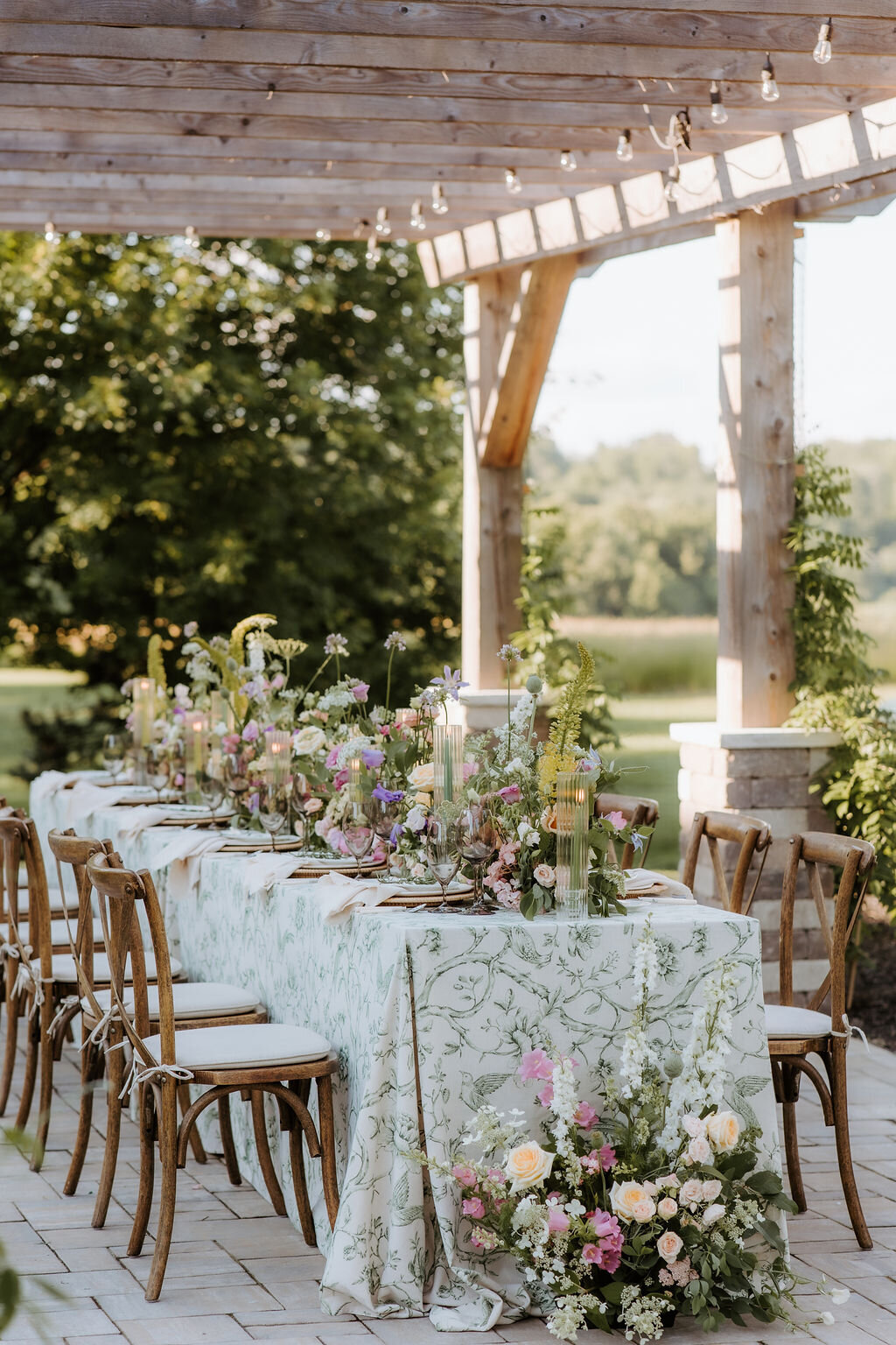 a beautiful table set for  an outdoor pergola reception at Willowbrook wedding venue