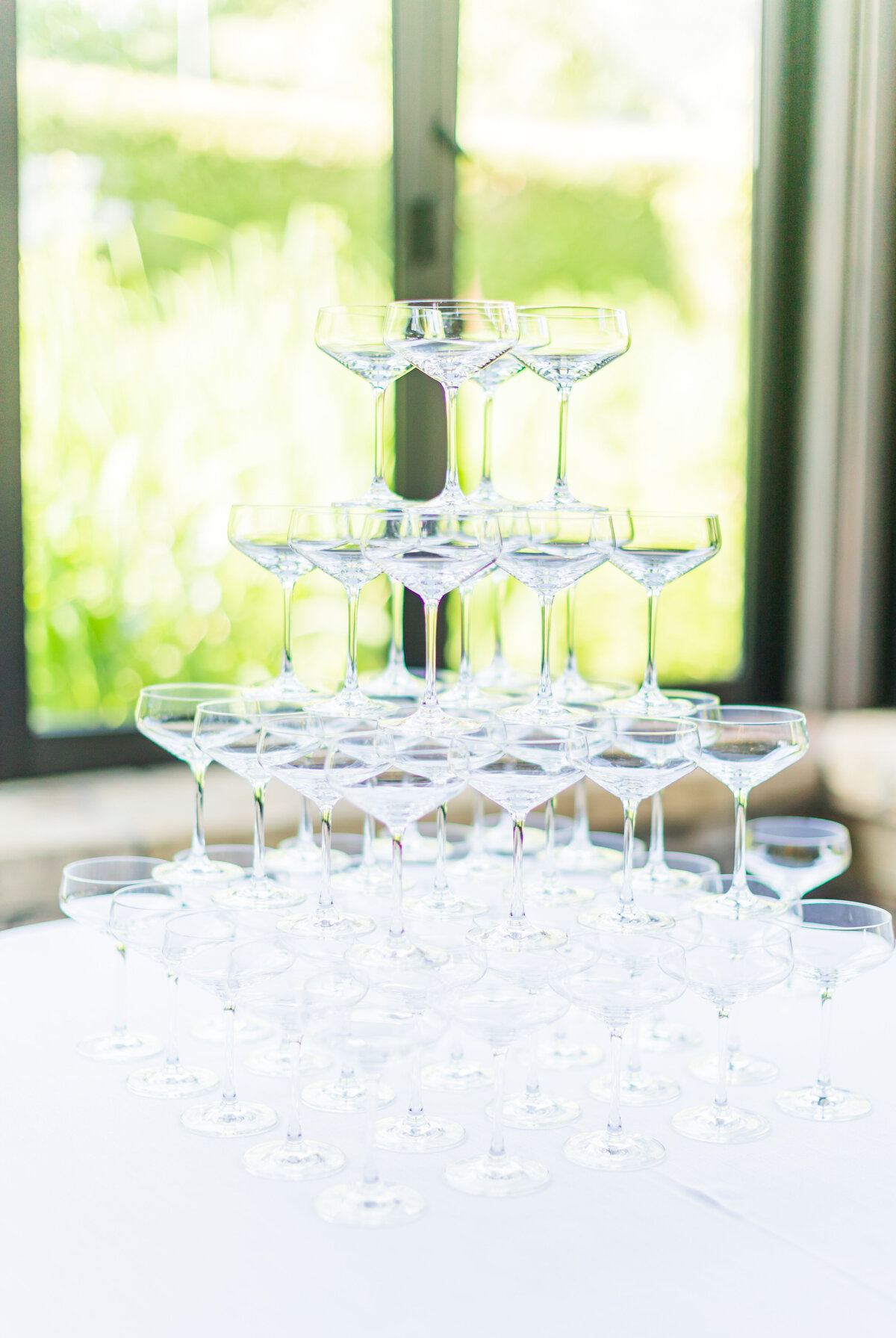 champagne glasses stacked at wedding reception
