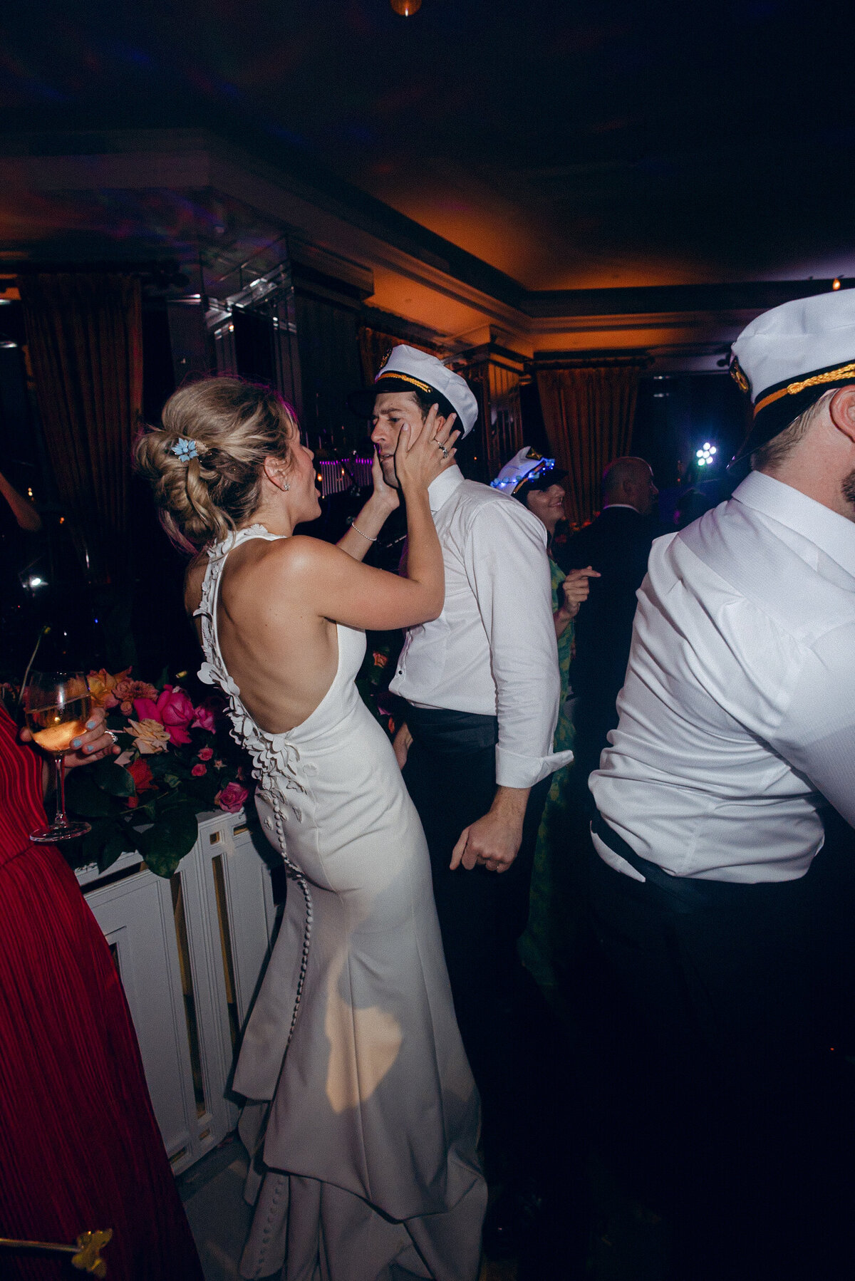 A wedding photo of the bride and groom during a candid moment during their wedding reception
