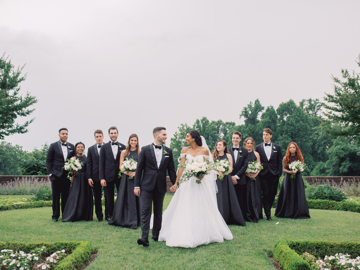 Bride, groom, and bridal party in the gardens at Oxon Hill Manor