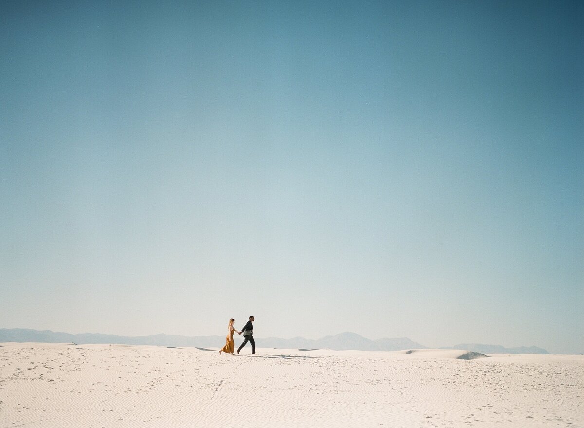 couples takes a stroll through white sands