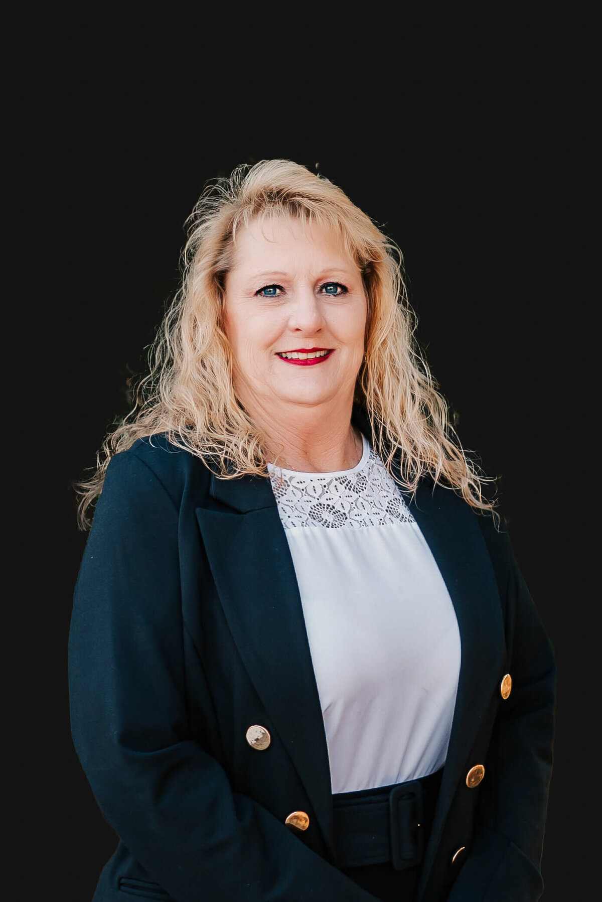 Springfield MO Professional headshot of woman in black against black background