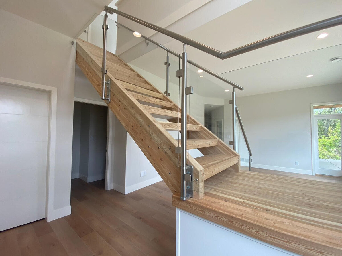 Modern stairwell design with hardwood and steel railings.