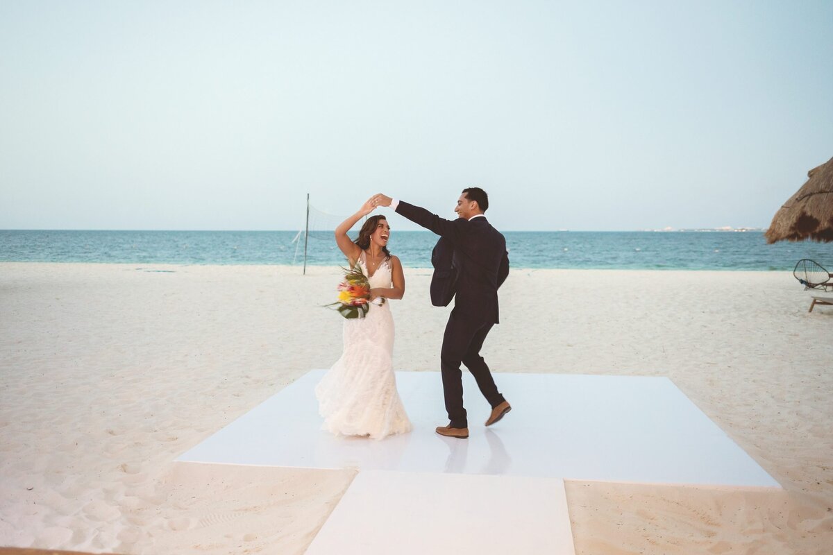 Bride and groom dancing on dance floor alone on beach at Cancun Wedding
