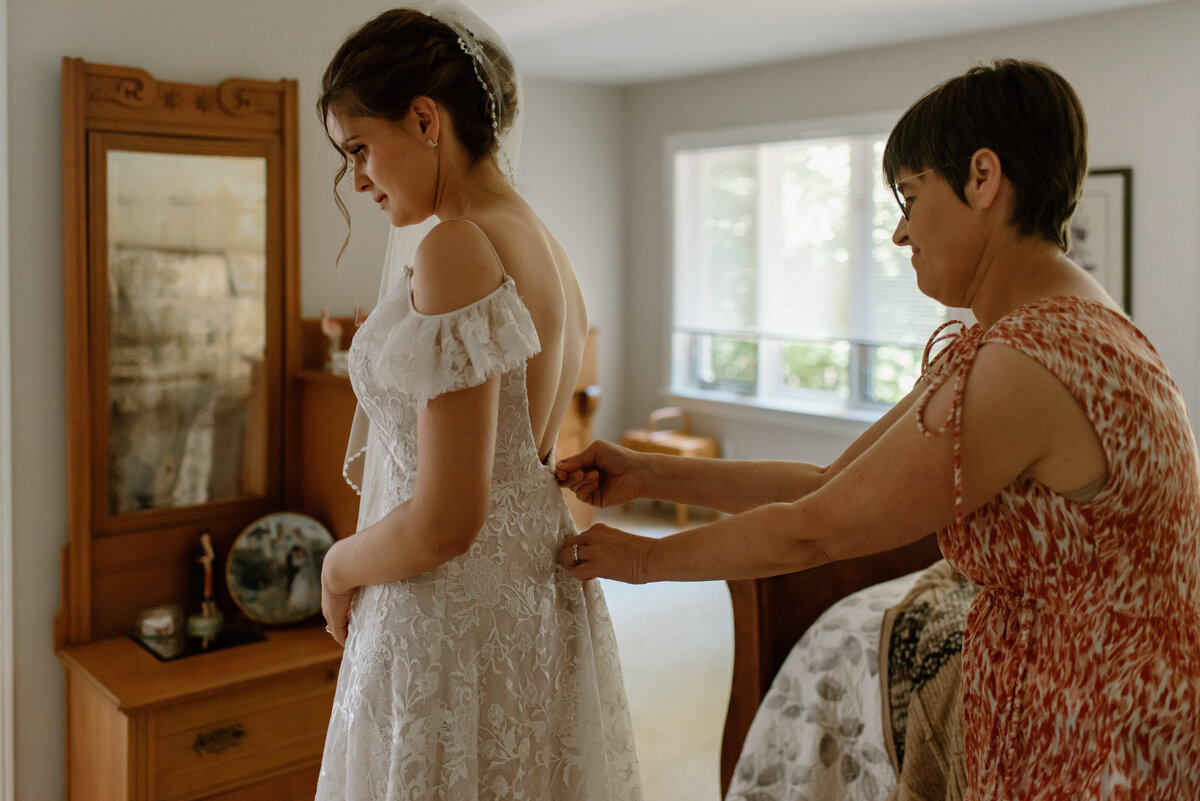 brantford ontario wedding bride has dress buttoned by mother