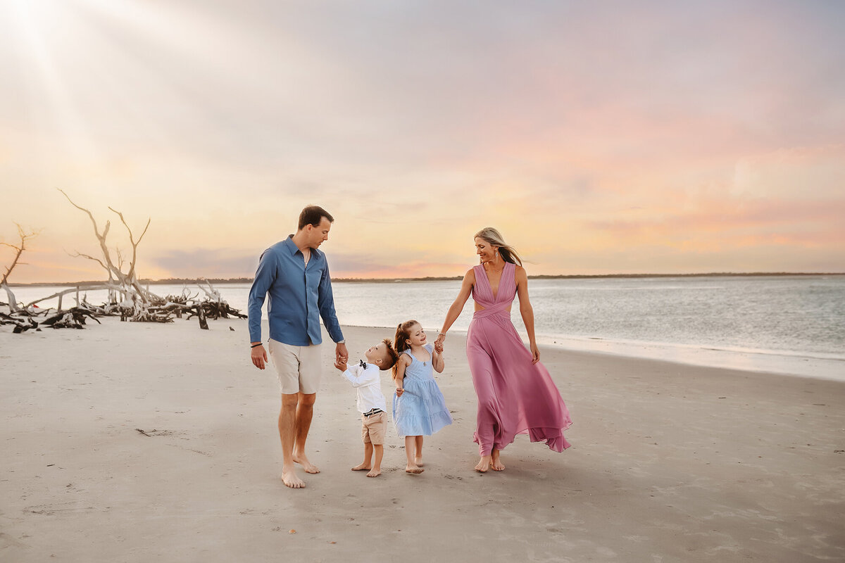 Family walks along the beach during Family Photos on Folly Beach.
