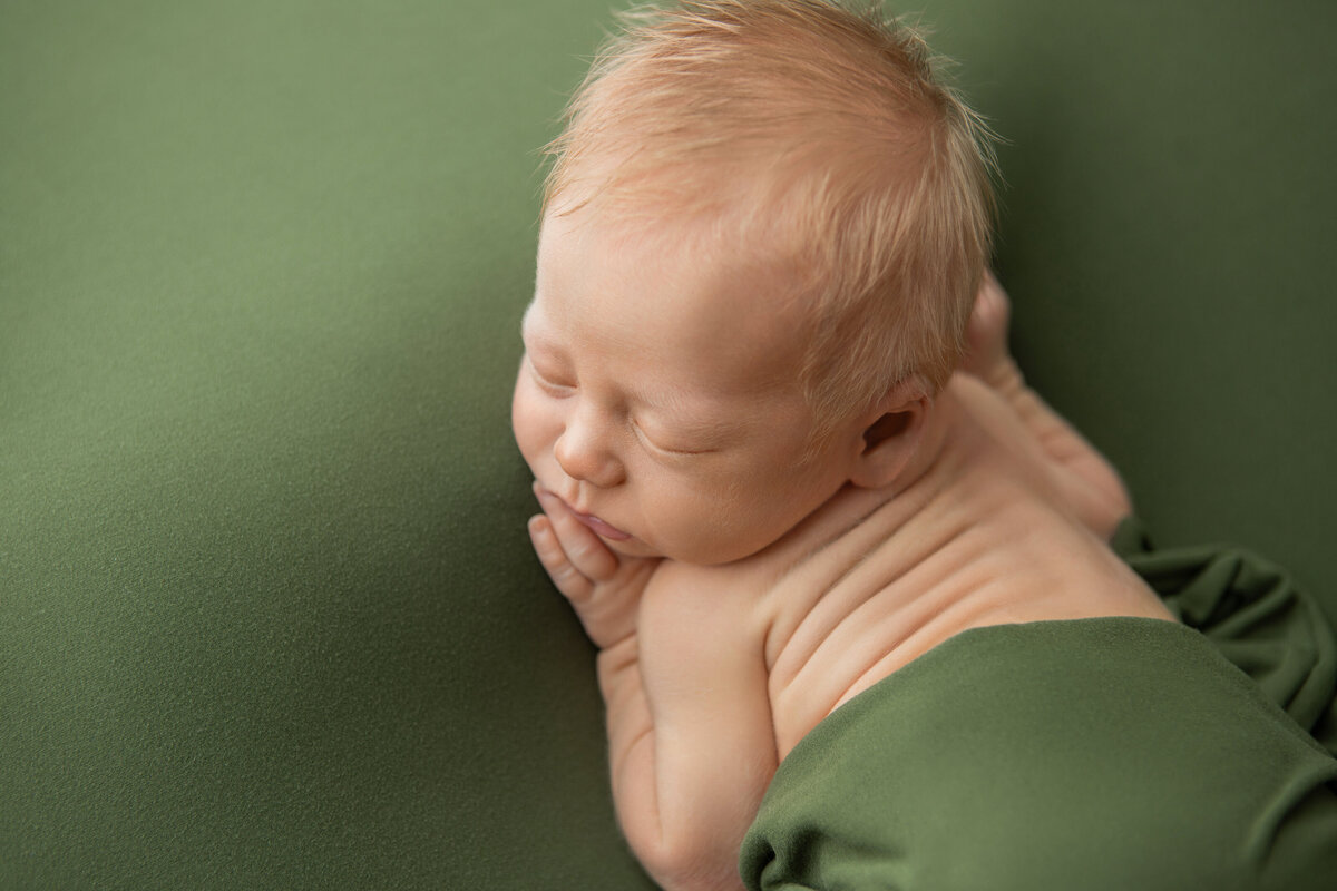 Edmonton newborn studio photoshoot bum up pose on sage green backdrop