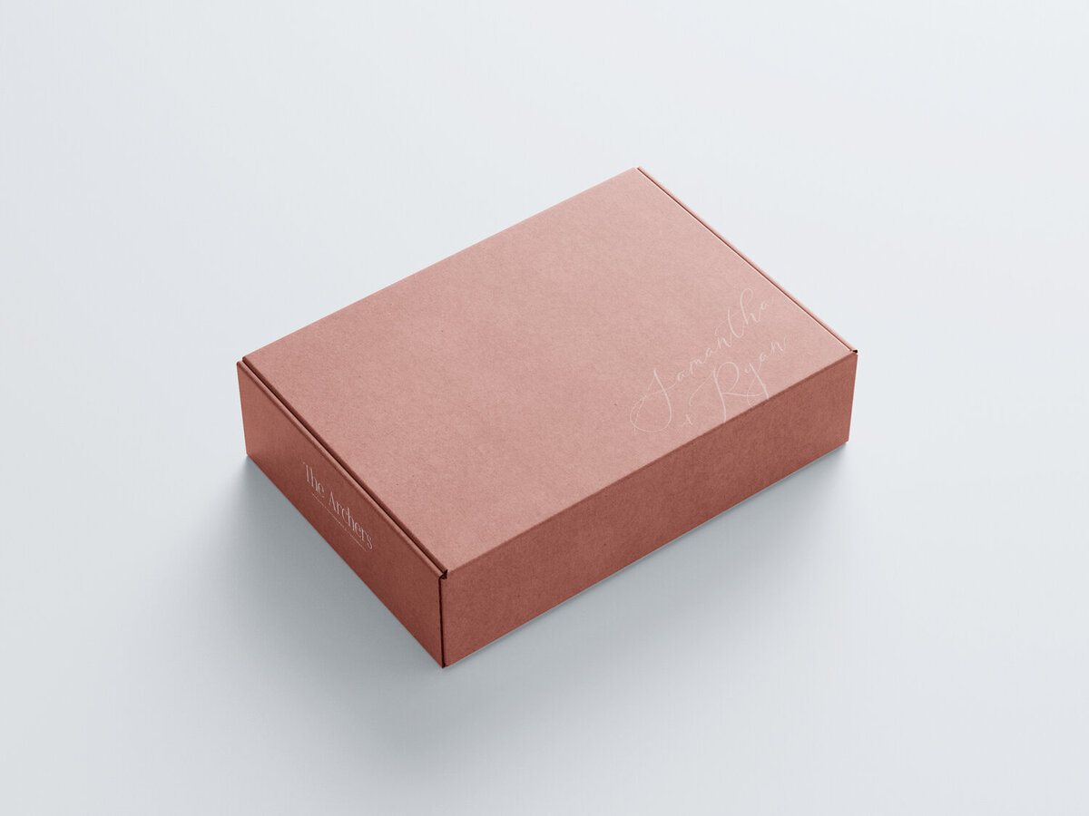 a mockup of a red gift box with a photographer's logo on it