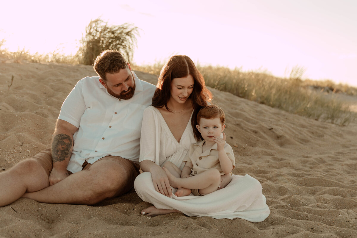 A family posing at Sandy Hook Beach for a family photo