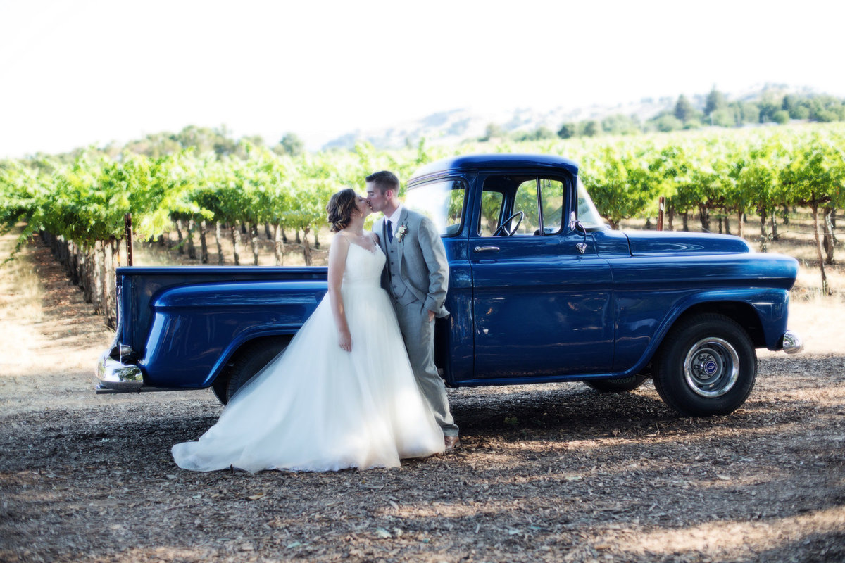 vintage truck with bride and groom