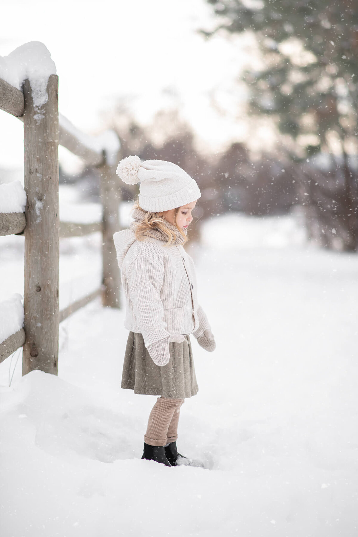 Young girl wearing layers and a skirt in the winter in Kamloops. Portrait by Brittany Danielle.