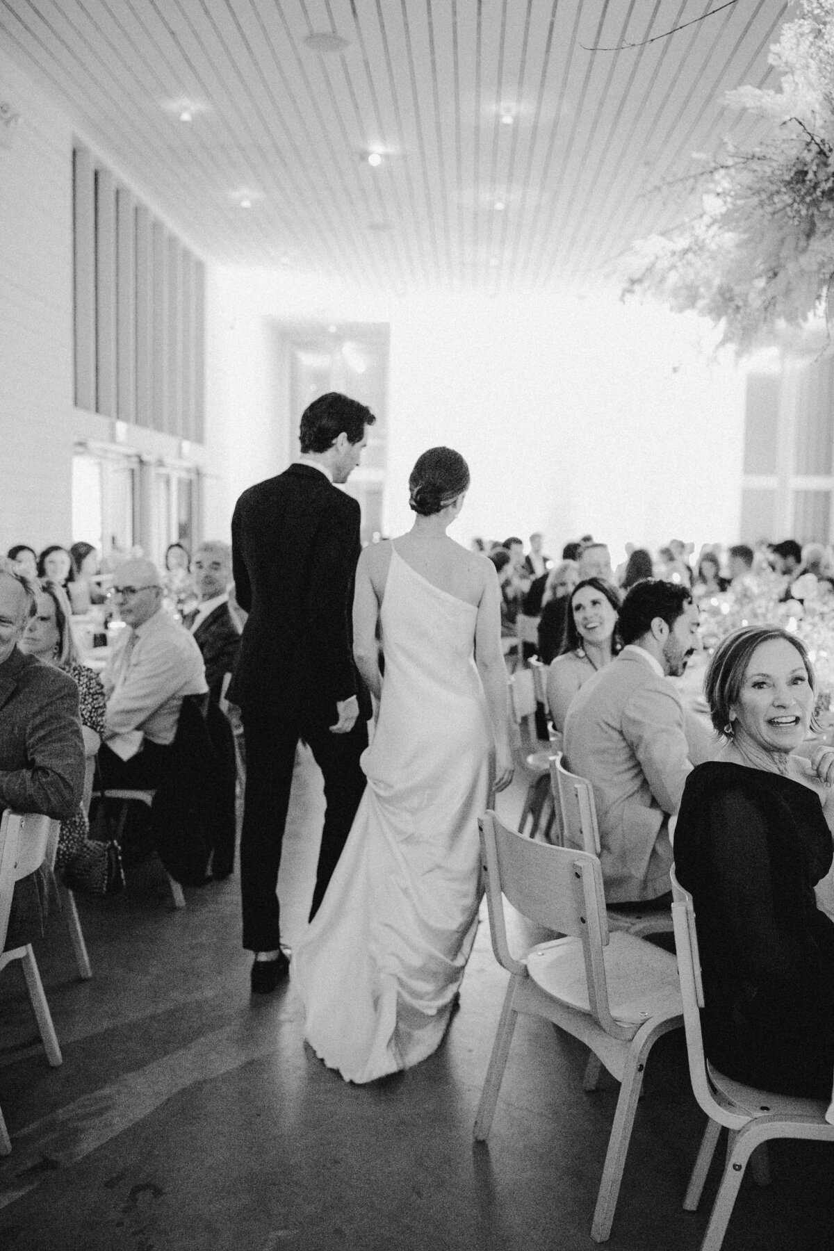 Bride and groom walking through wedding reception at Prospect House, Austin