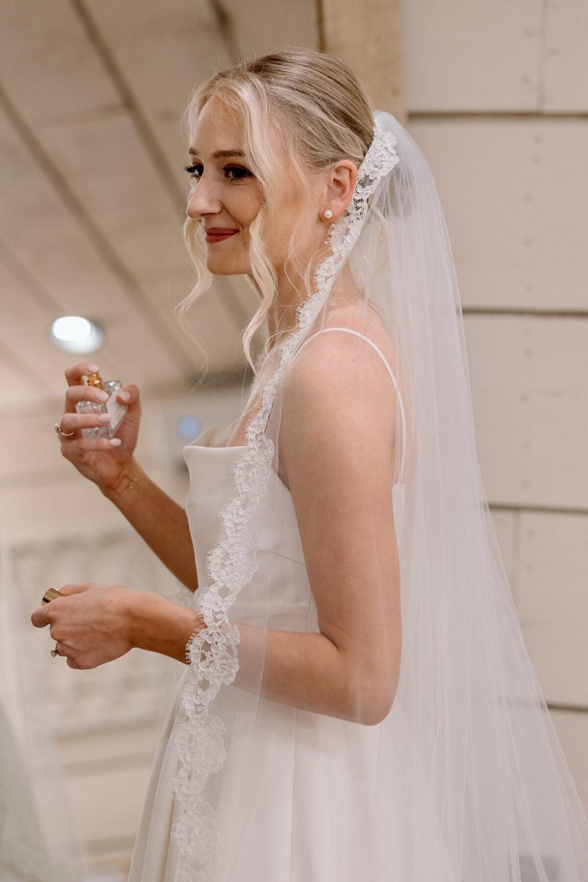 Bride spritzes her perfume