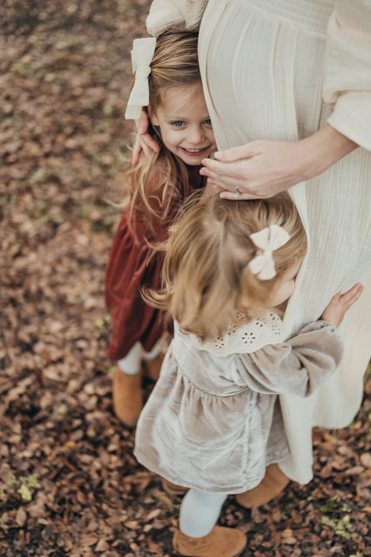 girls-hugging-mom-maternity-photo