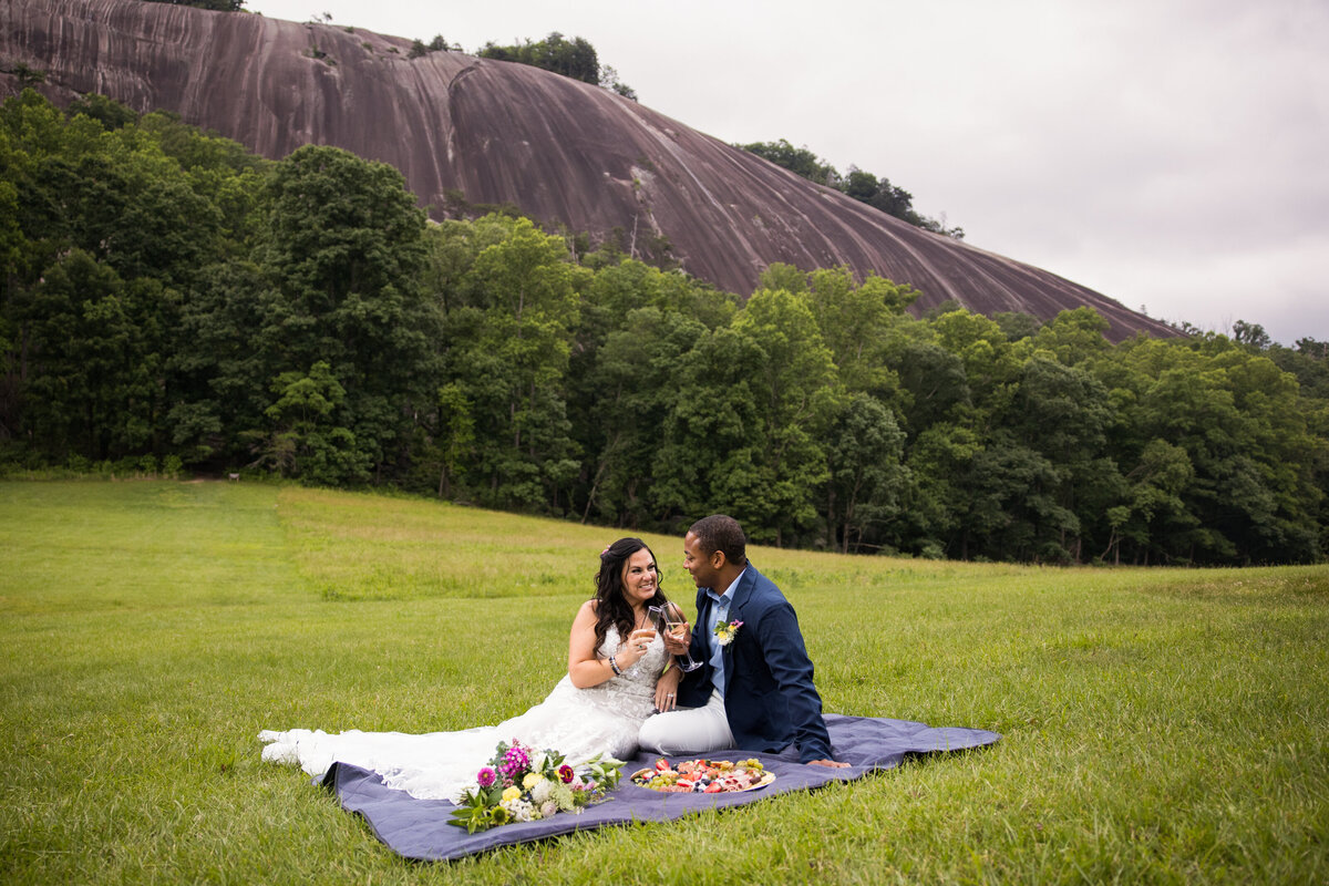 couple shares a picnic after their elopement at stone mountain in nc