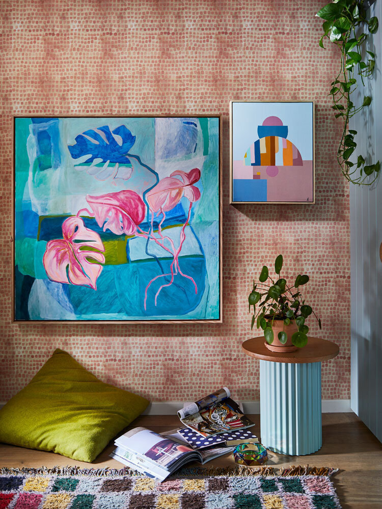 Bright botanical painting styled above custom sideboard with layered ceramics and foliage