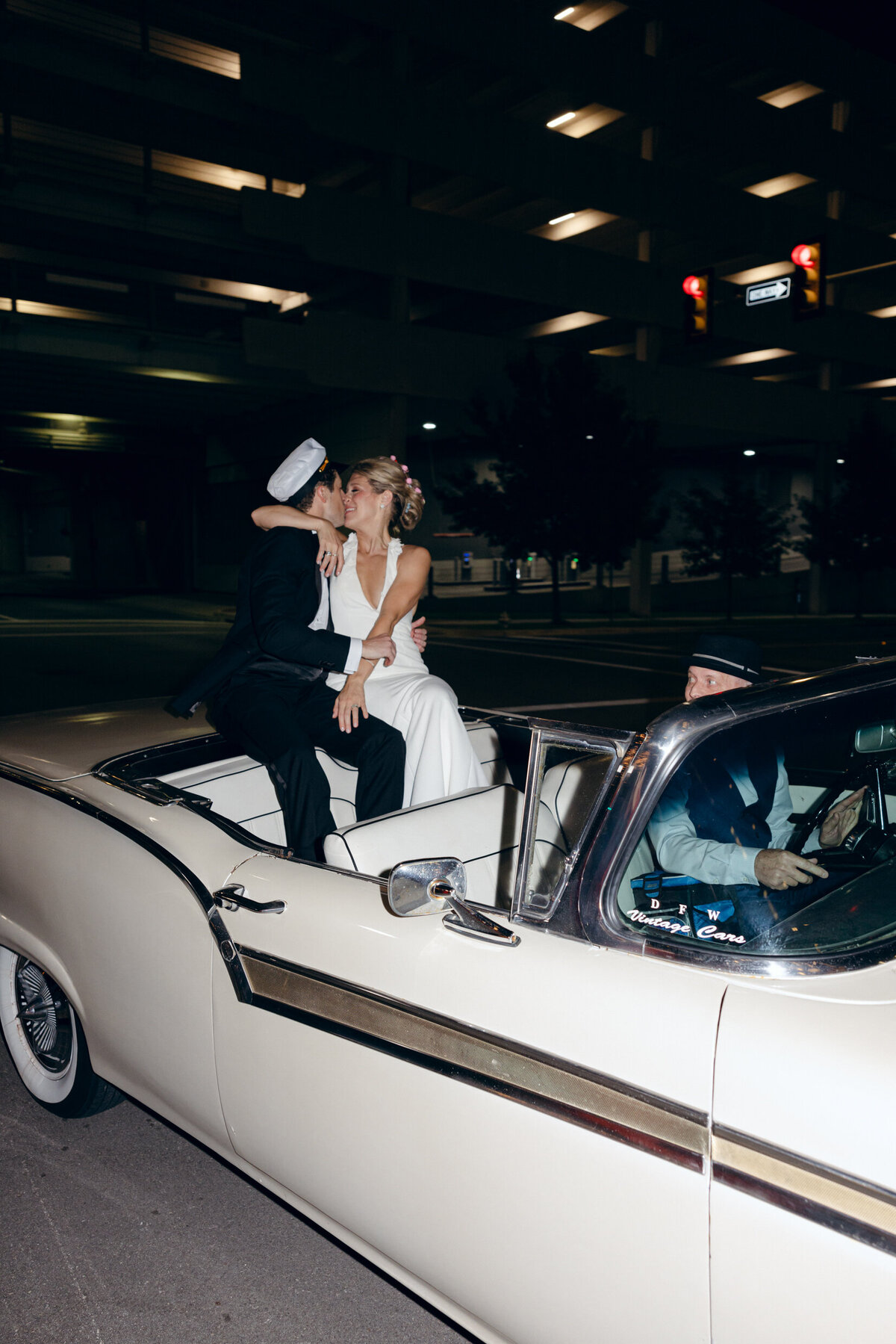 A wedding photo of the bride and groom in their getaway car in Forth Worth Texas