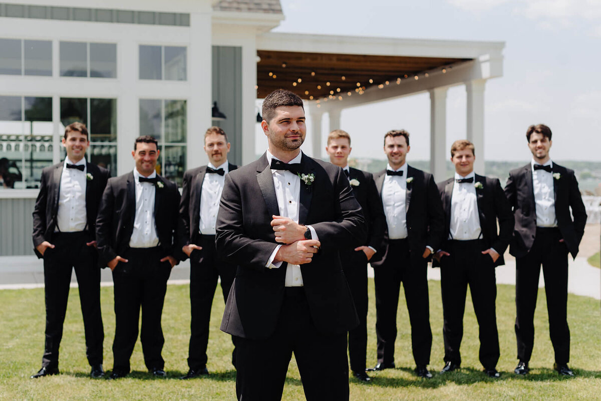 Groom standing in front of groomsmen at Canandaigua Country Club wedding, NY