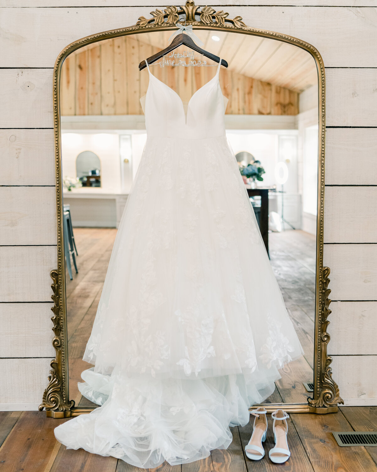 Dress hanging from mirror at bridal suite iat Koury Farms Wedding Venue in North Georgia