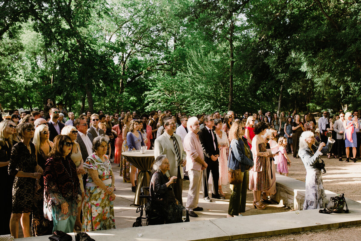 Wedding guests at wedding ceremony at Umlauf Sculpture Garden, Austin