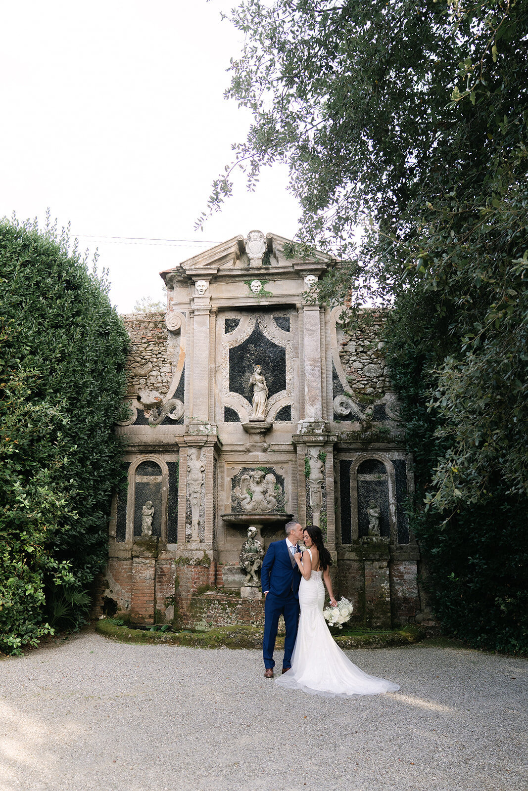 Bride and groom posing at a luxury Tuscan villa