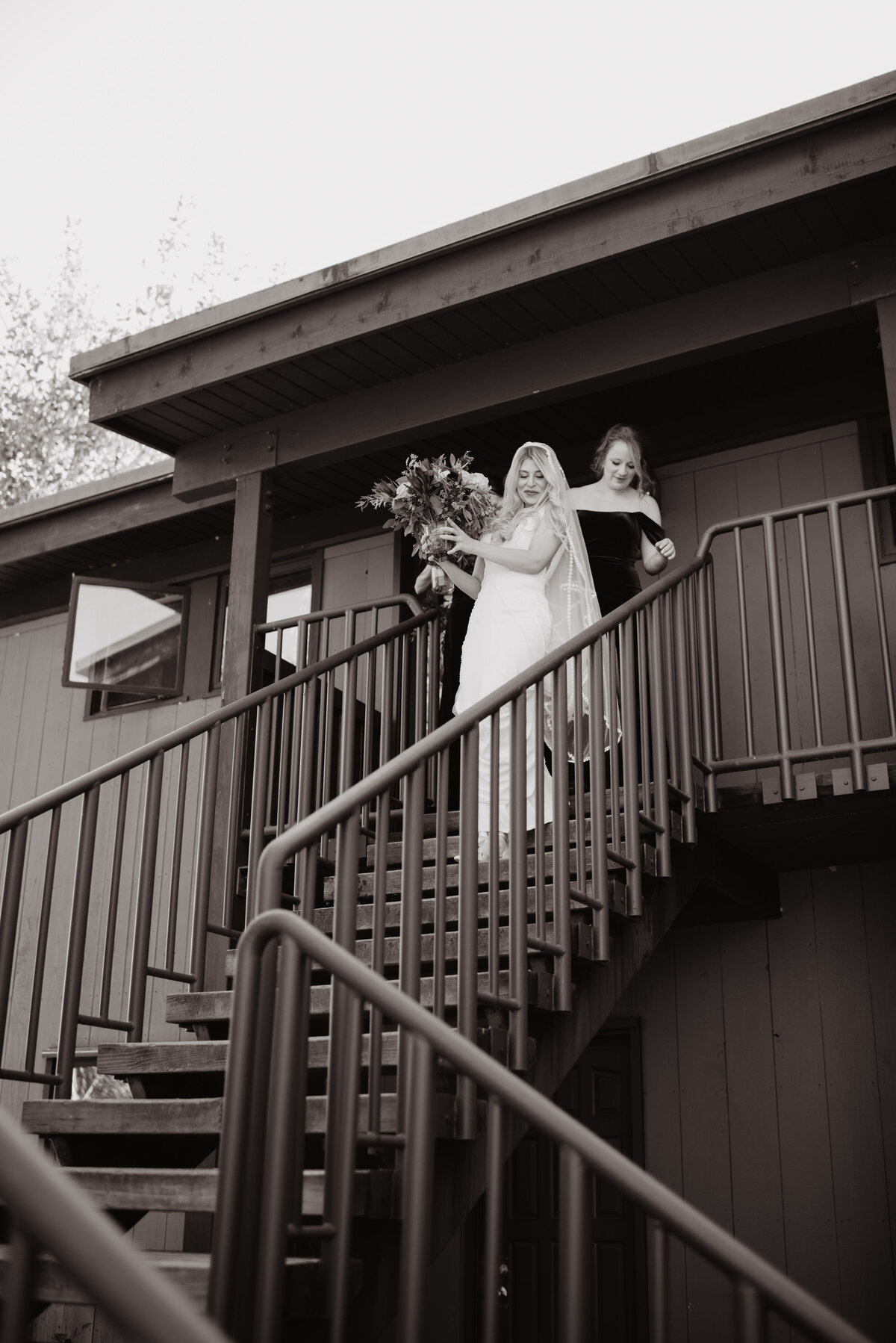 Photographers Jackson Hole capture bride walking downstairs in bridal gown