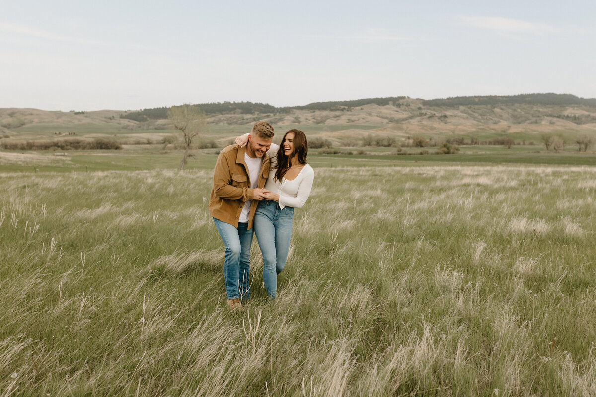 wisconsin couples engagement session running through field photographer mariah jones photography