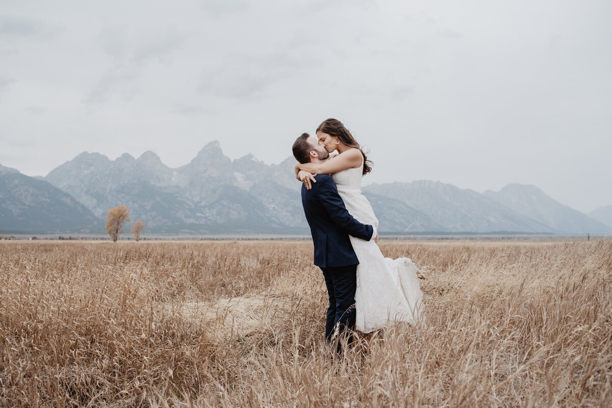 Photographers Jackson Hole capture bride and groom embrace during bridal portraits