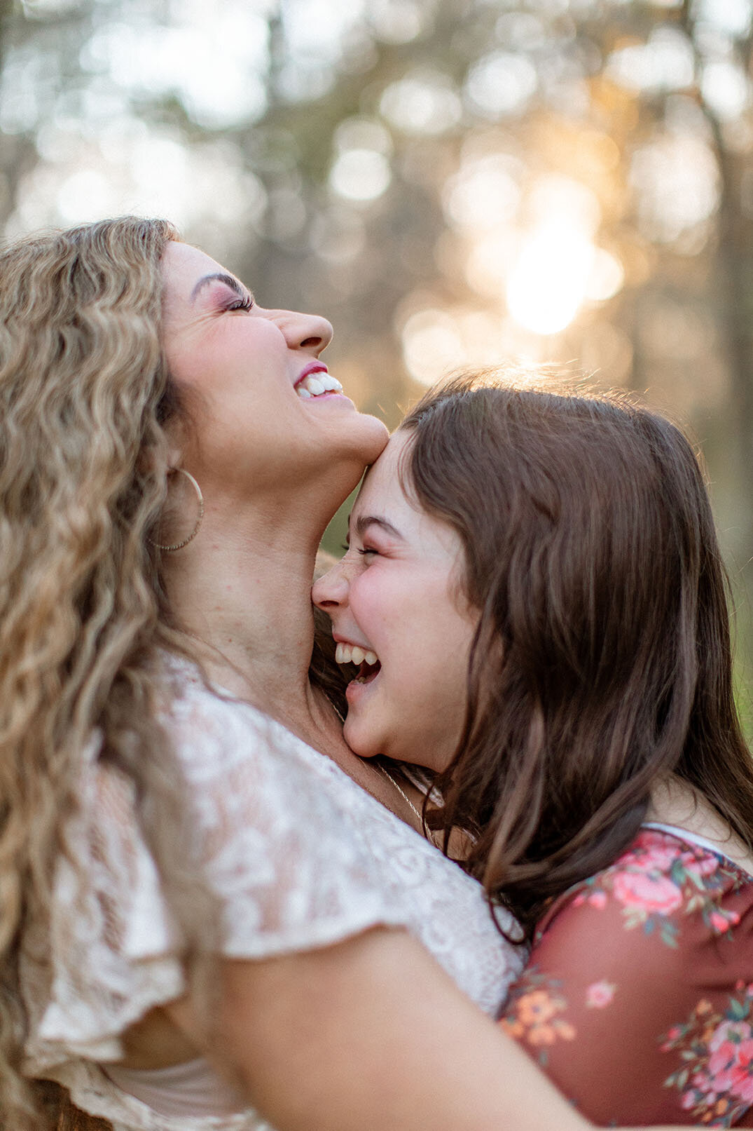 Candid portrait of a mother and daughter laughing together, captured by San Antonio photographer Sara James.