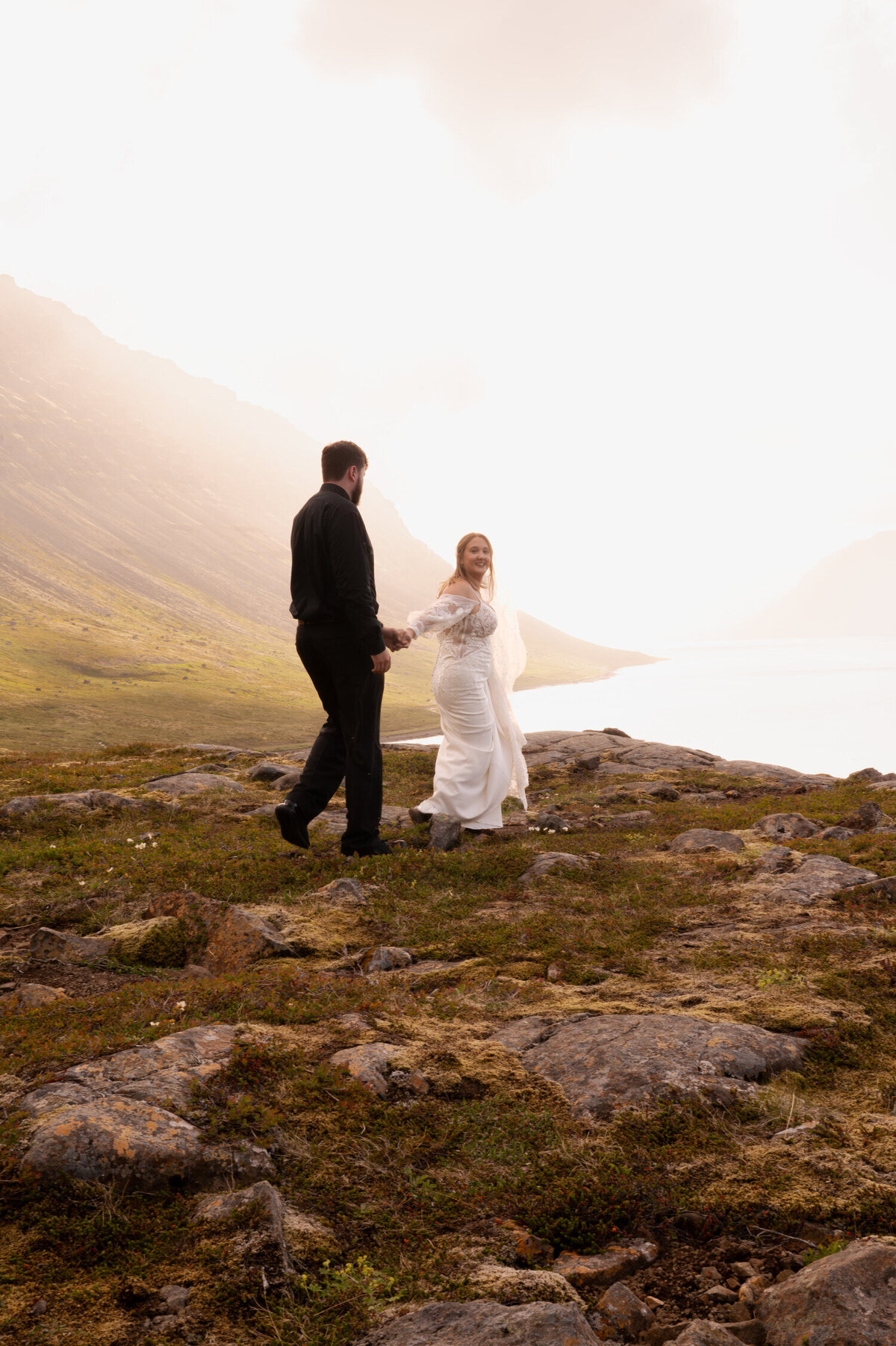 Bridal portraits on the cliffs of the Westfjords in Iceland at Dynjandi Waterfall to celebrate the bride and grooms Iceland elopement.