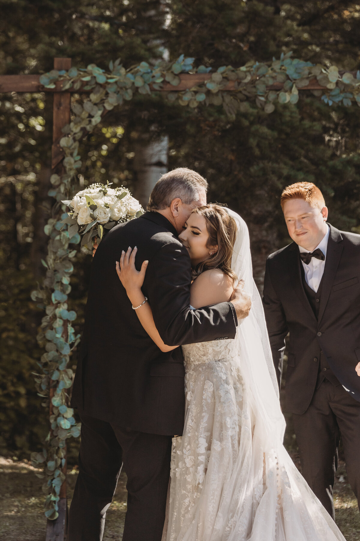 Bride and dad hugging at Alberta ceremony