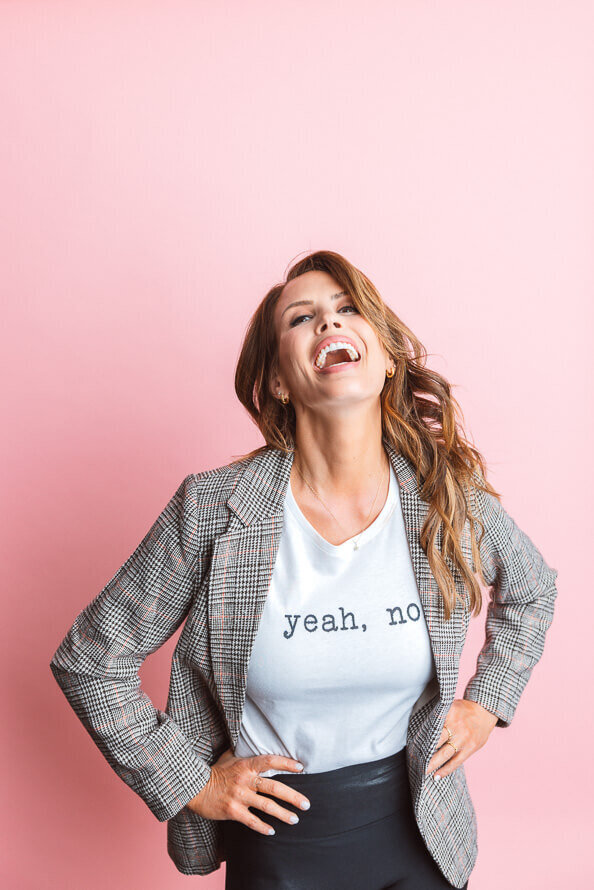Girl with shirt that says Yeah No  throws her head back and laughs.