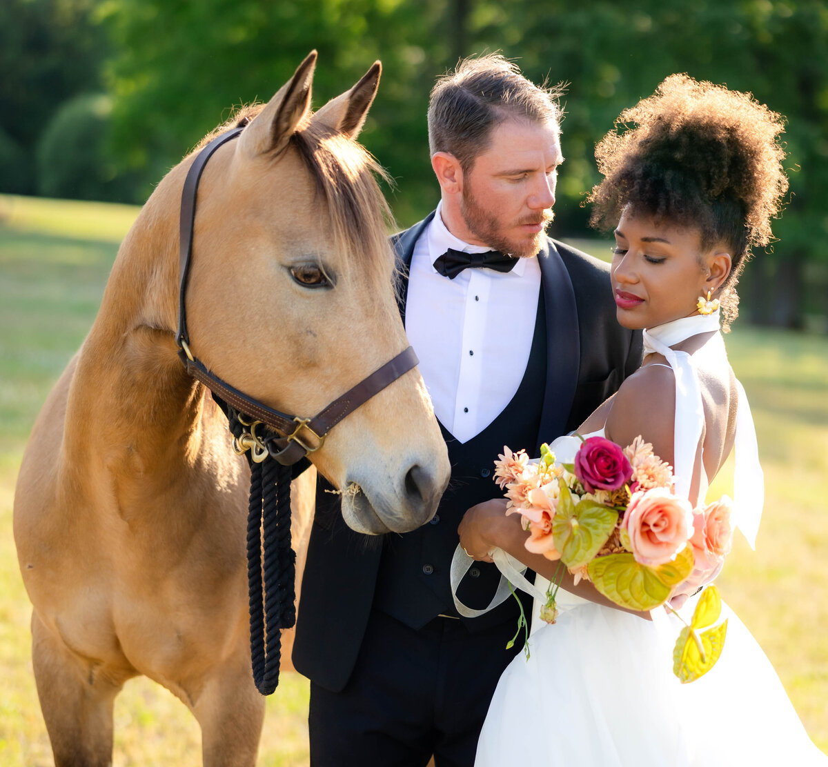 Bride, Groom and Her horse in lovely wedding day photo full of wistful glances.