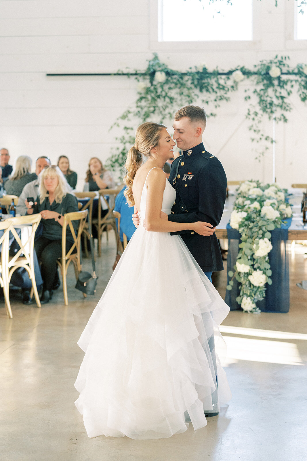 groom in military uniform slow dancing with his bride