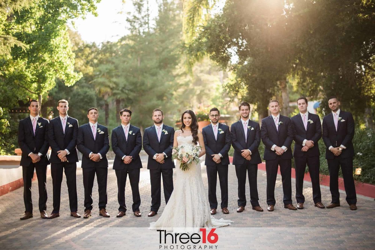 Bride posing with 10 Groomsmen