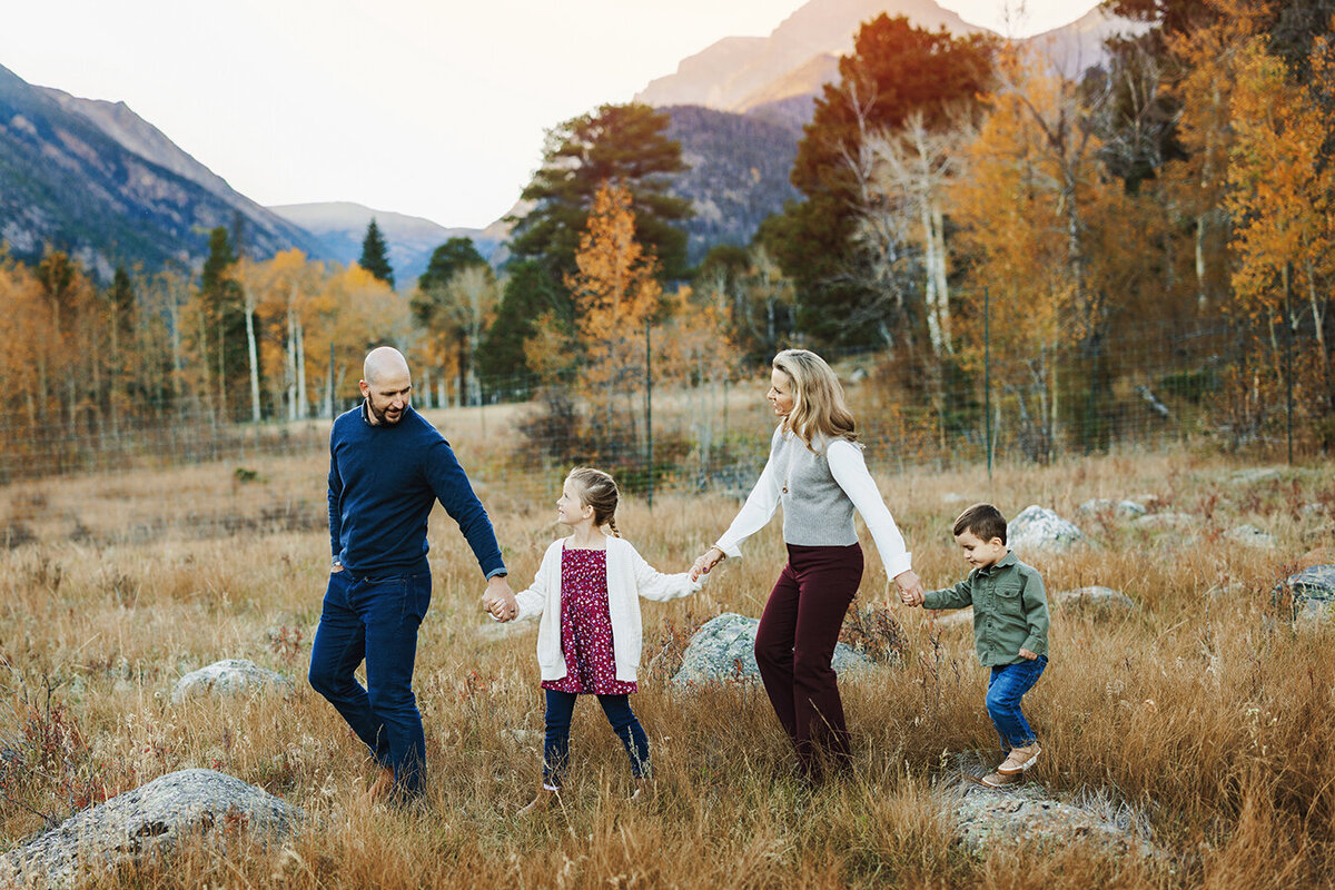Family walking in the mountains of Estes Park for photos