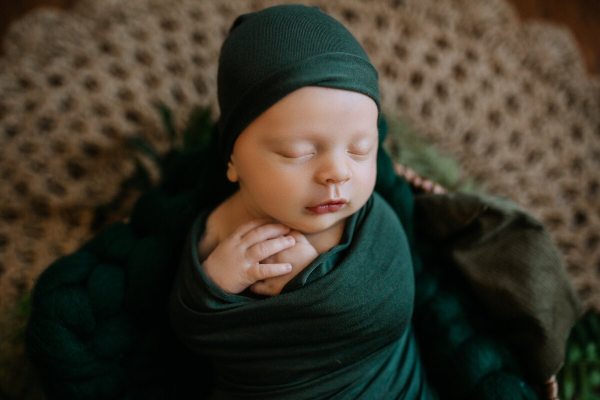 posed newborn in green wrap in Harrisonburg, VA