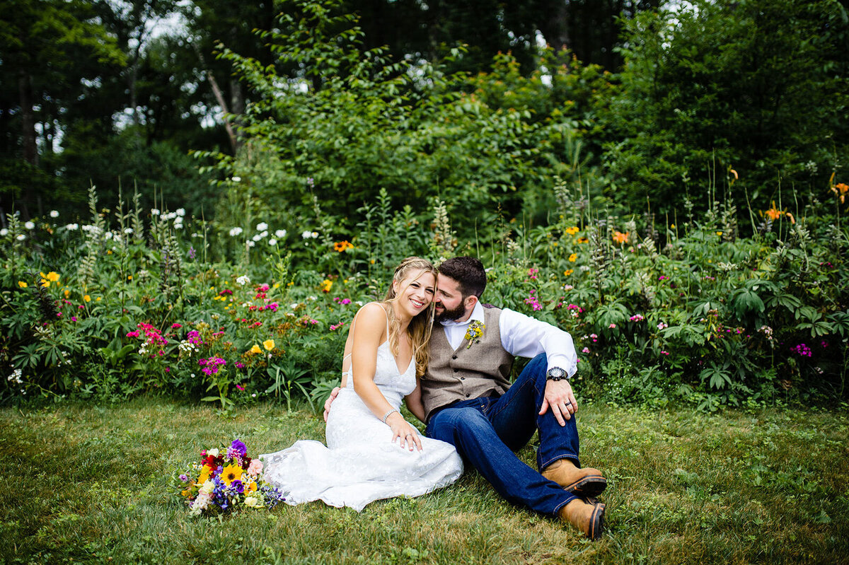 microwedding bride and groom sitting in wildflowers vermont adventure