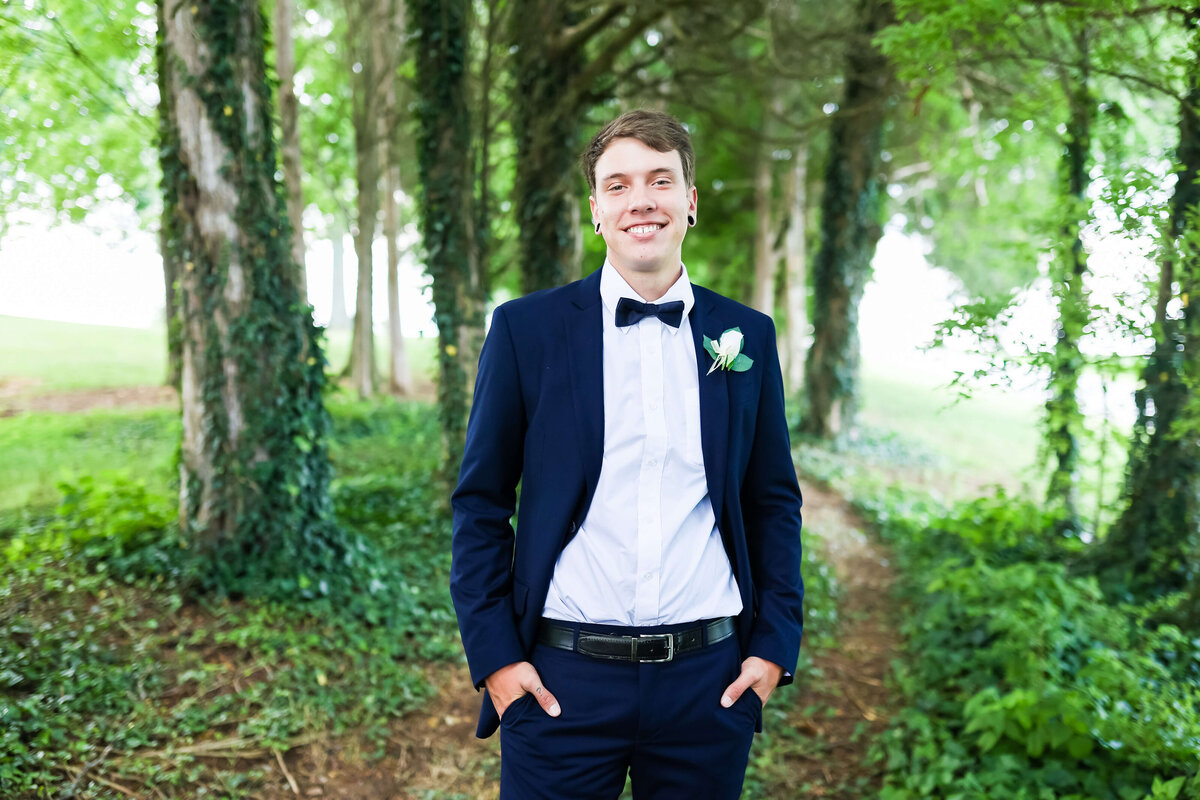 Groom wearing black tuxedo at  Ruby Cora wedding venue in Clarksville, TB