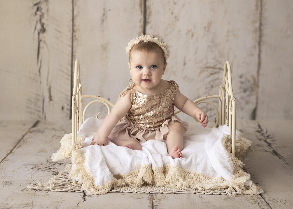 MILESTONE_SITTER_BABYGIRLSITTINGONBABYBEDINPINKSPARKLES