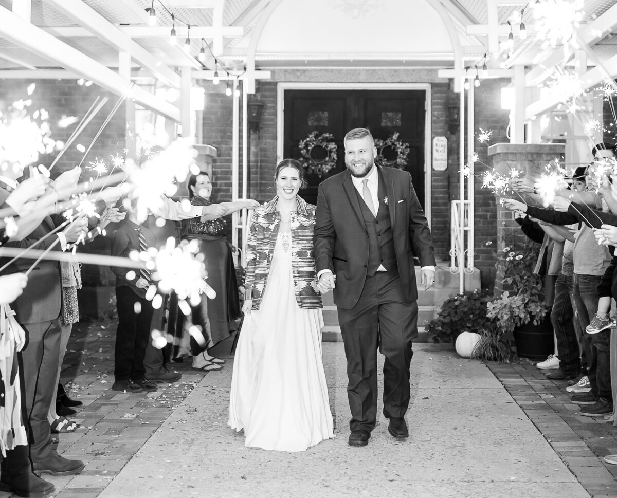Robin Kunzler Photo takes sparkler photo of Bride and Groom coming out fo the Hearthside event center in Eden, Utah