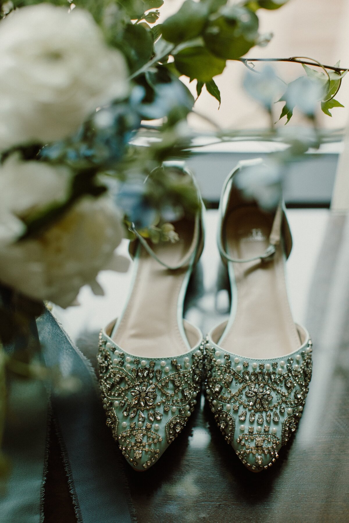 Light blue and jeweled wedding shoes.