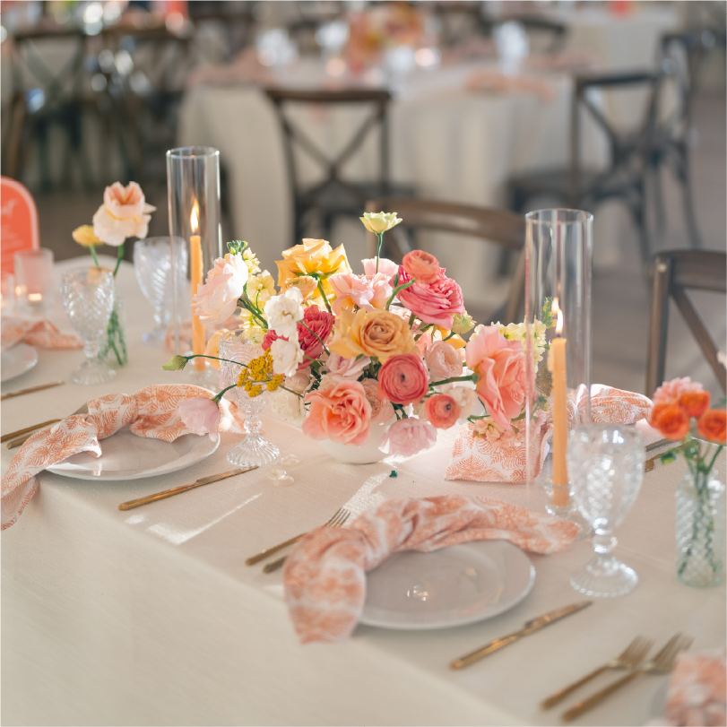 Wedding reception table decorated with peach and blush floral arrangements, perfect for stylish Austin corporate event decor or romantic wedding styling.