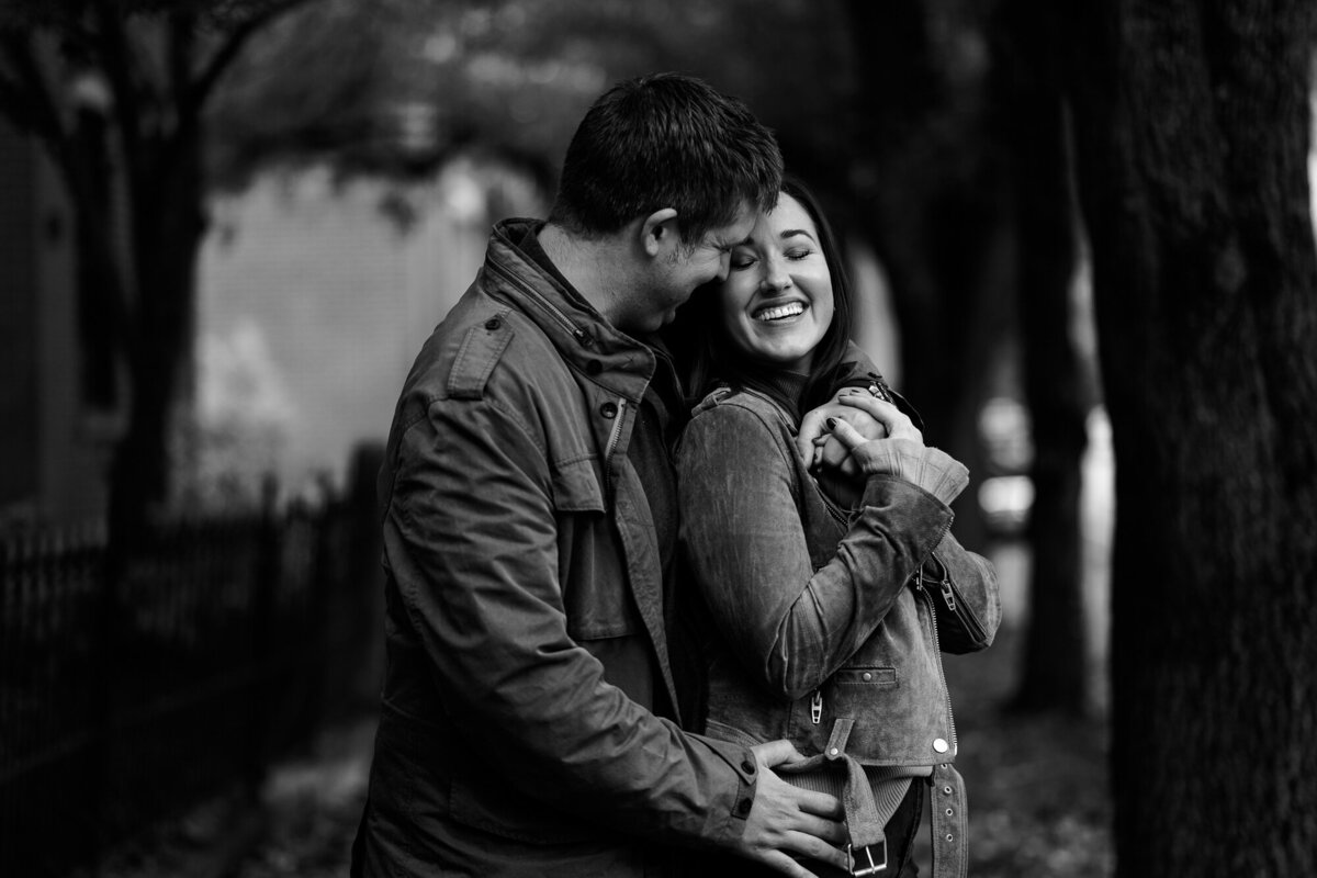 Man snuggles up with partner during engagement session