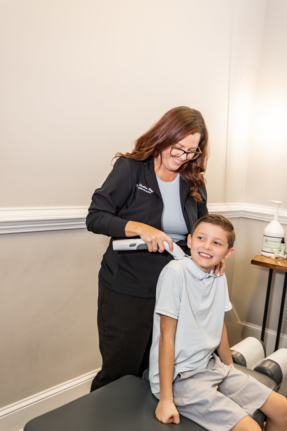 Dr. Buffkin massaging a child's shoulder