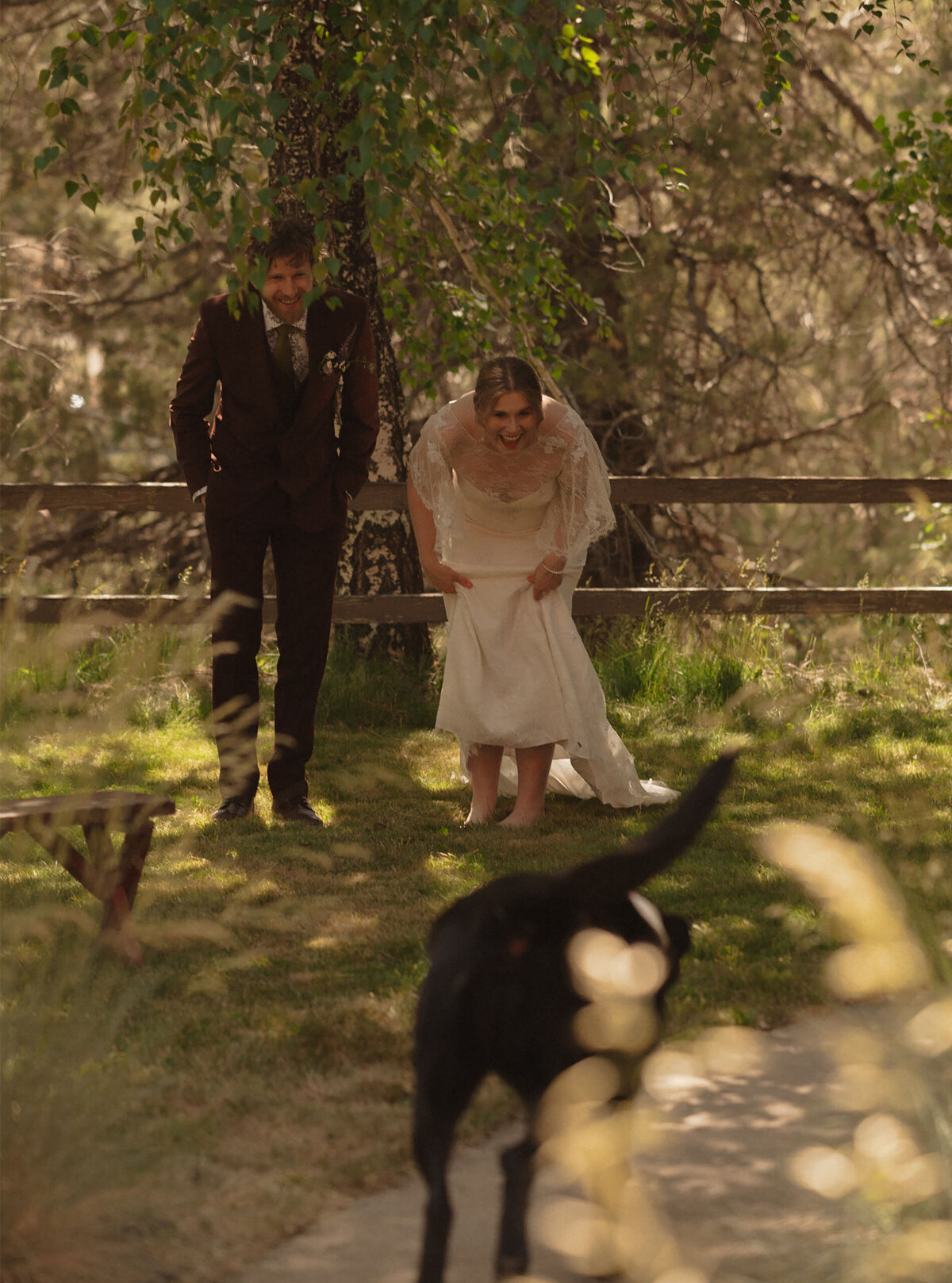 elopement couple smile and laugh as they call their dog during their intimate elopement session in Bend, Oregon