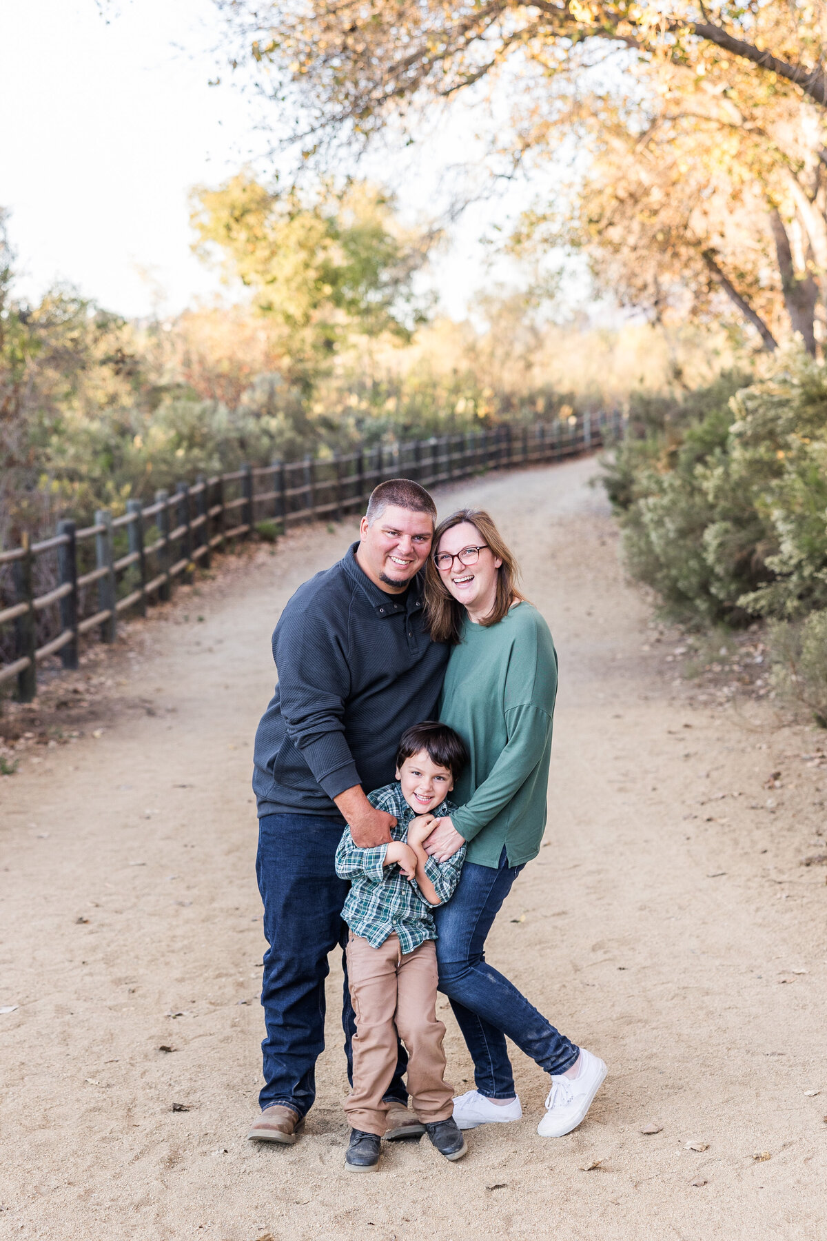 family hugging on trail in bonita san diego