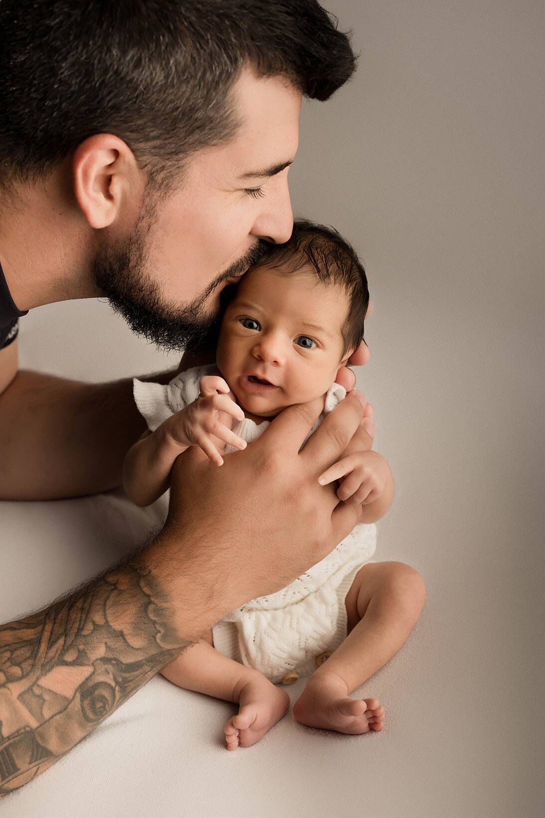 cute newborn photo of a dad and his wide eyed newborn