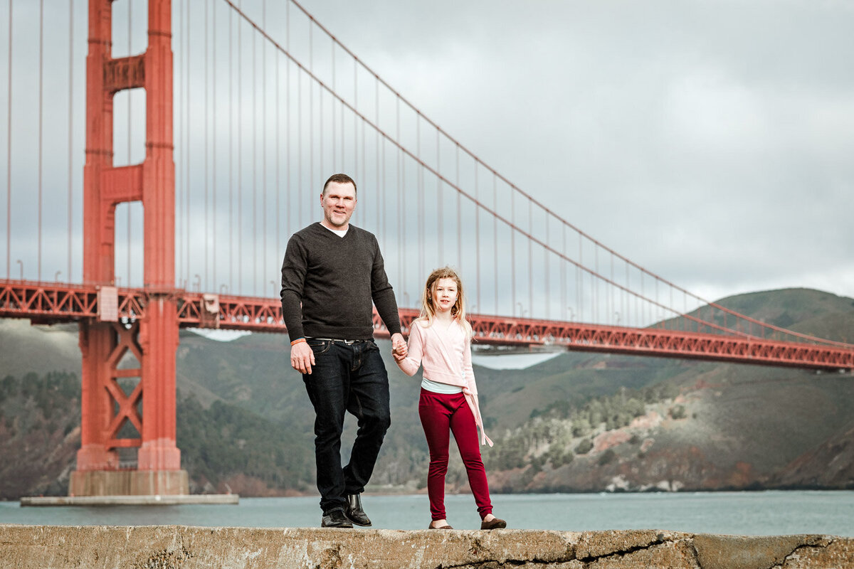 father and daughter by golden gate